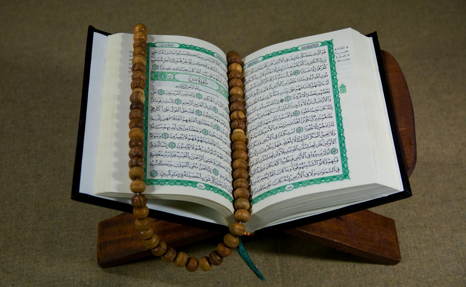 Close-Up Shot of a Book beside Prayer Beads